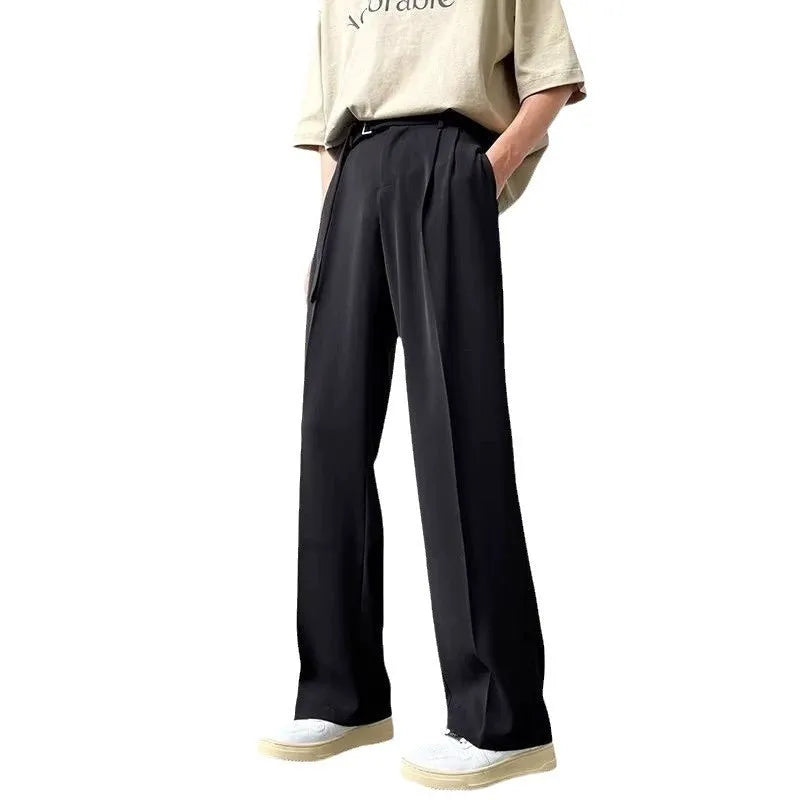 Man wearing thin straight-cut wide leg casual trousers in black, showcasing the loose fit and straight leg opening.