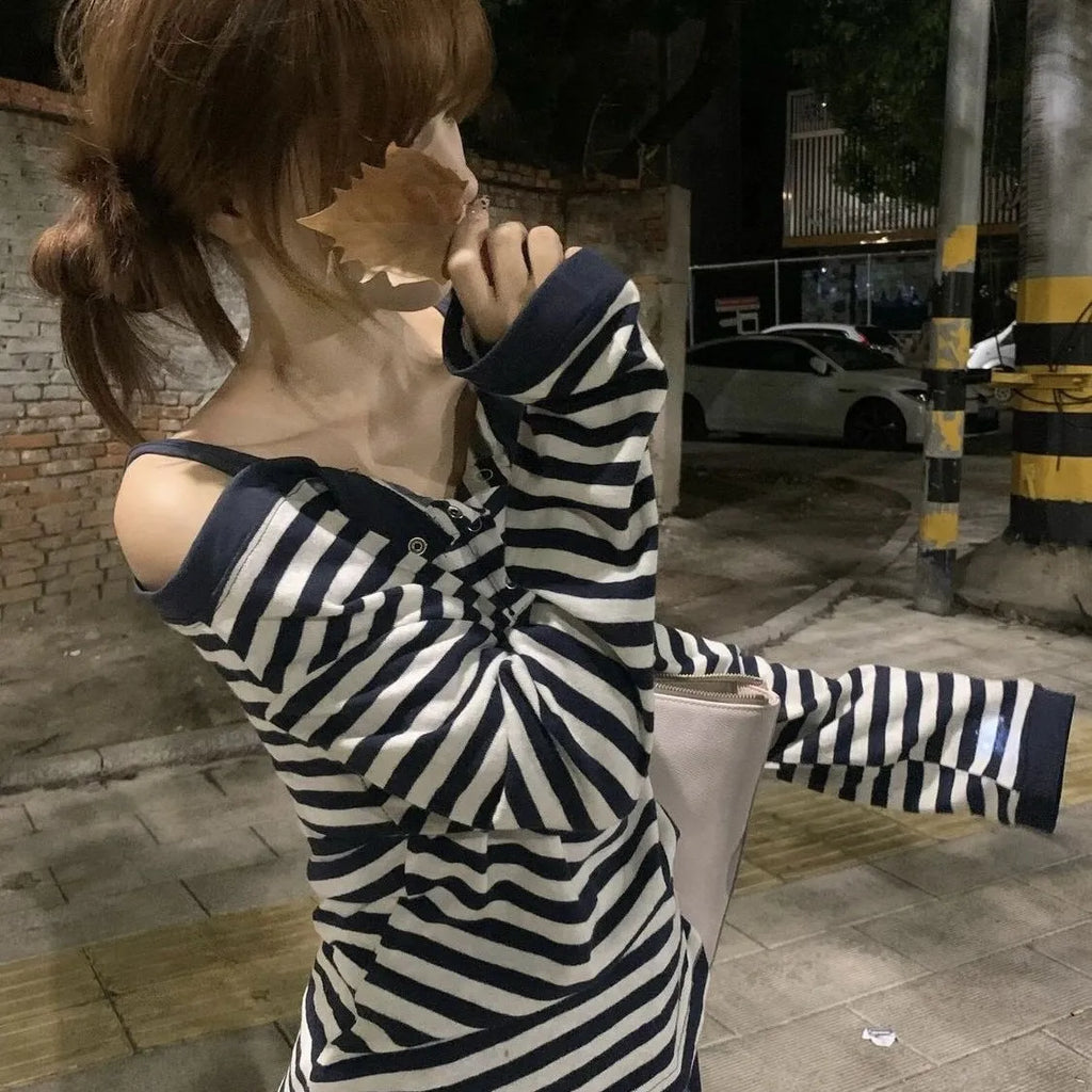 Dark blue Korean-style women's oversized long sleeve t-shirt with stripe and embroidery details on a hanger.