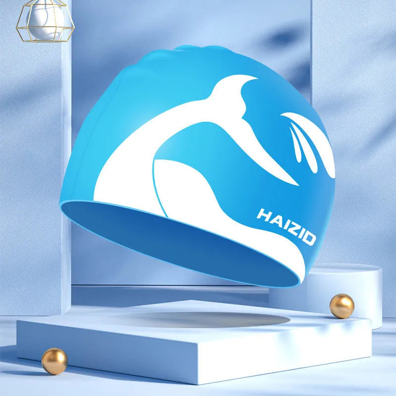 Adult unisex silicone swim cap with whale tail pattern and built-in ear protectors in four colours.