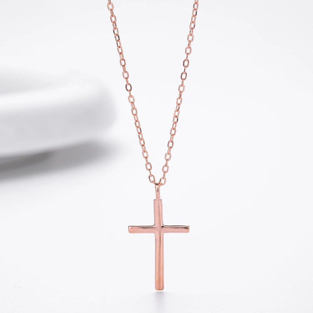 Simple glossy cross pendant on a sterling silver O-chain necklace, shown in gold, platinum, and rose gold finishes.