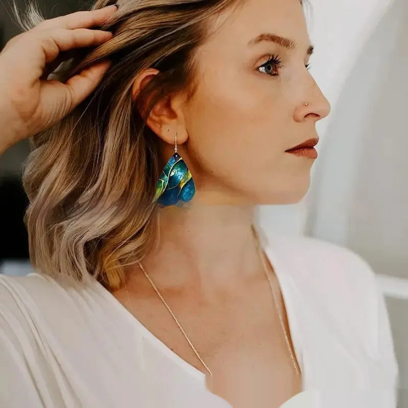 A pair of drop-shaped acrylic earrings featuring a printed flat branch knot design.