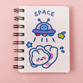 Astronaut-themed pocket flipper notebook showing compact 10.5 by 8 cm dimensions with space character cover options