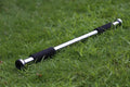 Steel adjustable pull-up bar extended between door frames for home fitness training