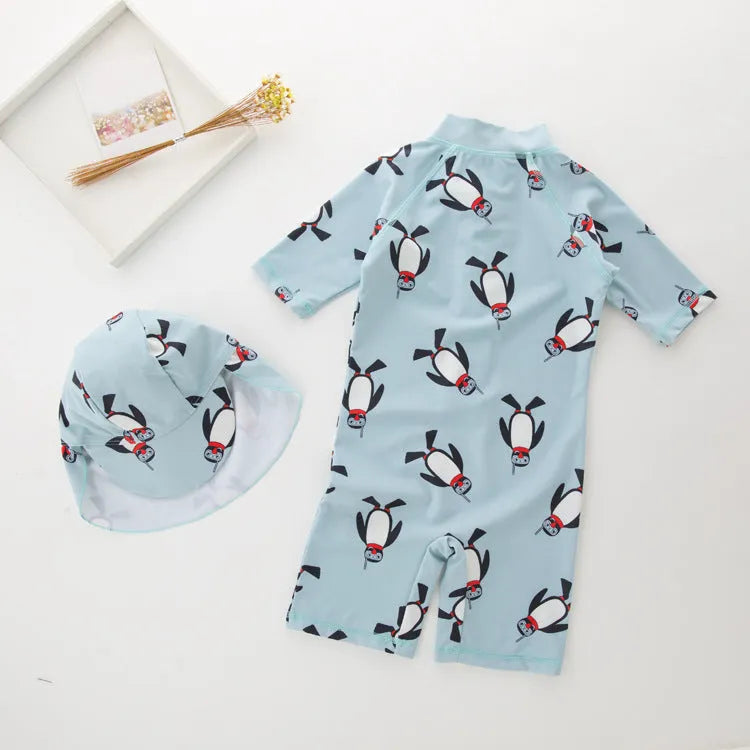 Boy's penguin print long sleeve swimsuit with matching swimming cap set on white background