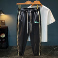 Men's black cotton harem trousers with elastic waistband shown front and back