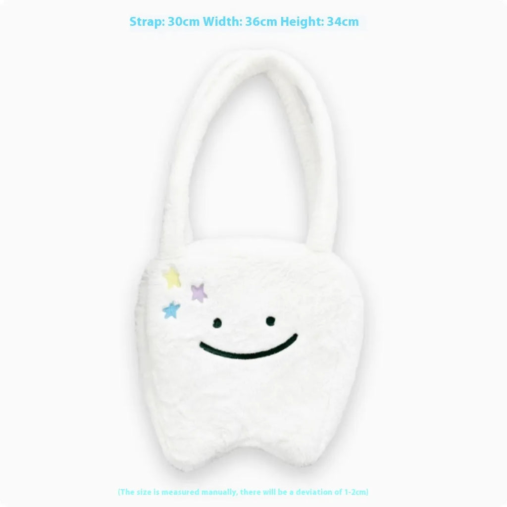 White plush large tooth design shoulder tote bag with zipper closure shown from the front.