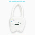White plush large tooth design shoulder tote bag with zipper closure shown from the front.
