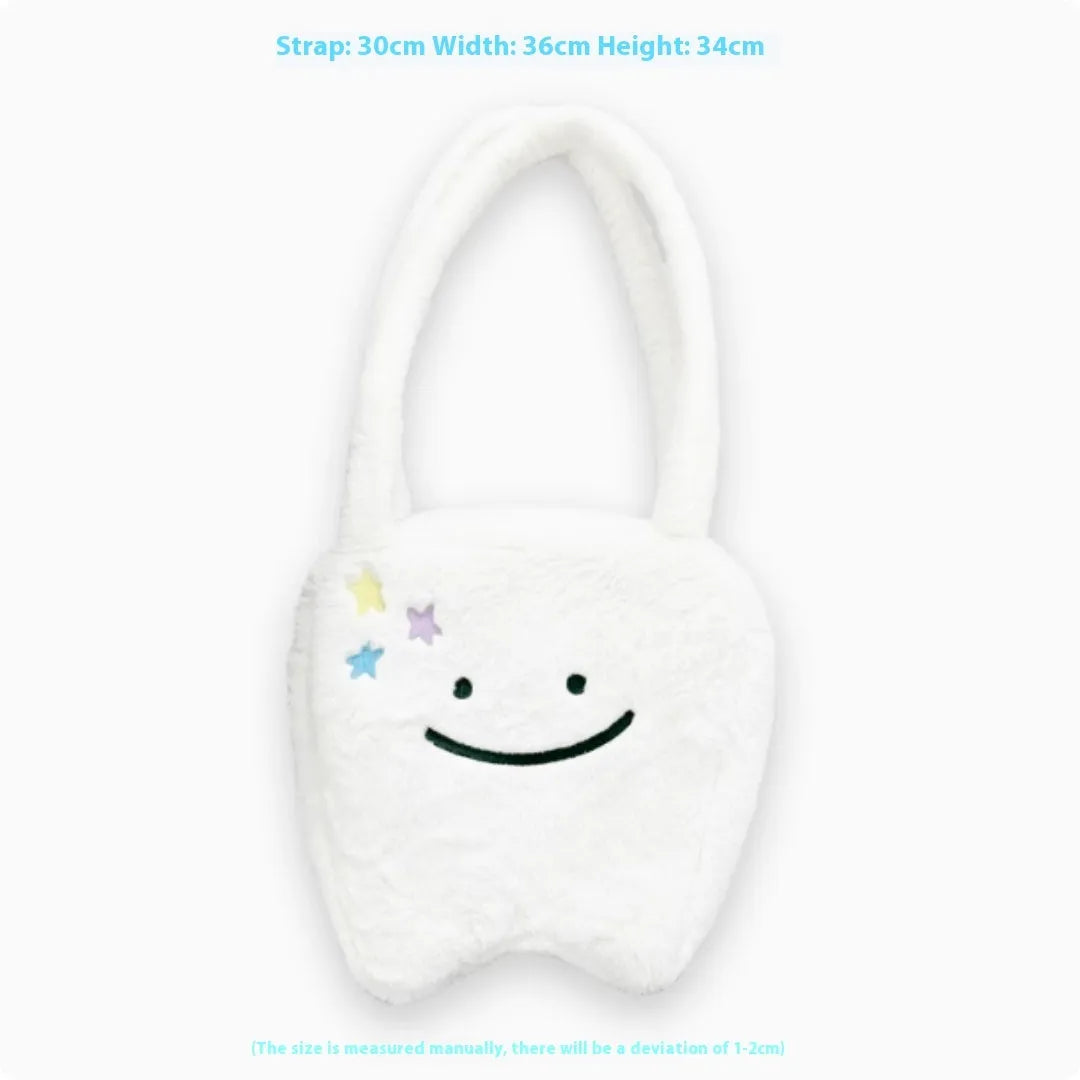White plush large tooth design shoulder tote bag with zipper closure shown from the front.