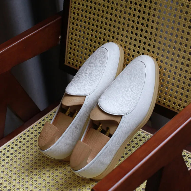 Men's brown genuine leather handmade loafers with a flexible TPR sole on a white background.