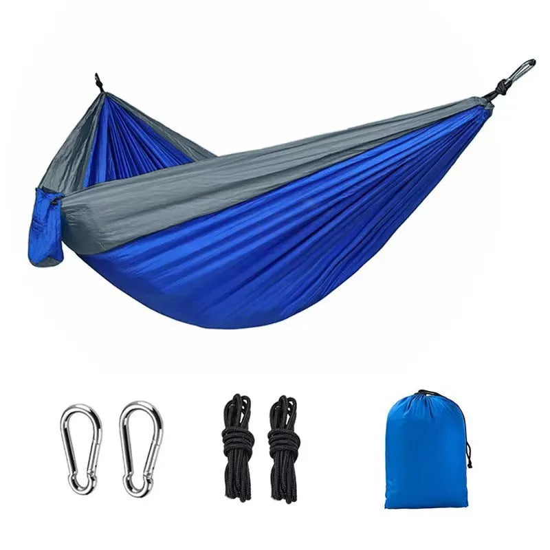 Blue nylon parachute cloth outdoor hammock hung between two trees showing full 270 cm length