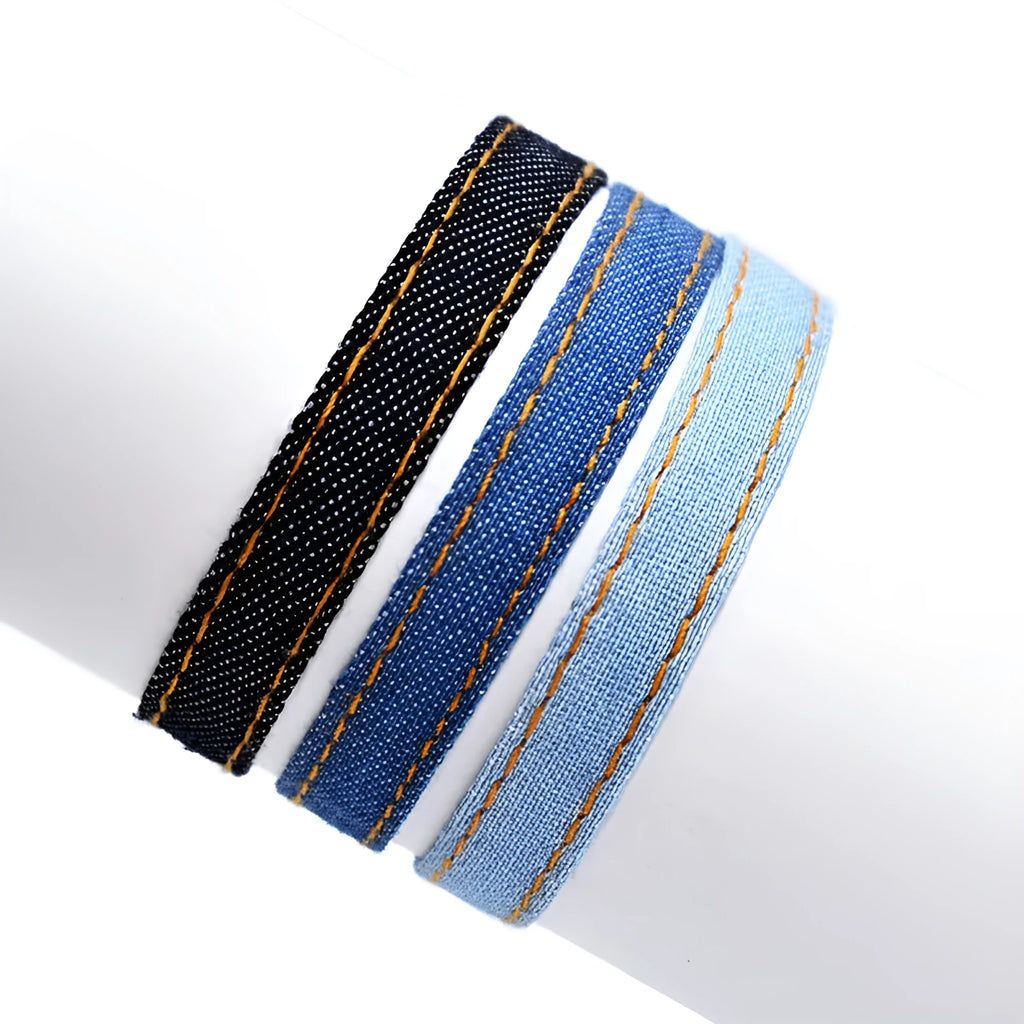 Denim fabric bracelet carrying strap with mixed material construction in unisex design