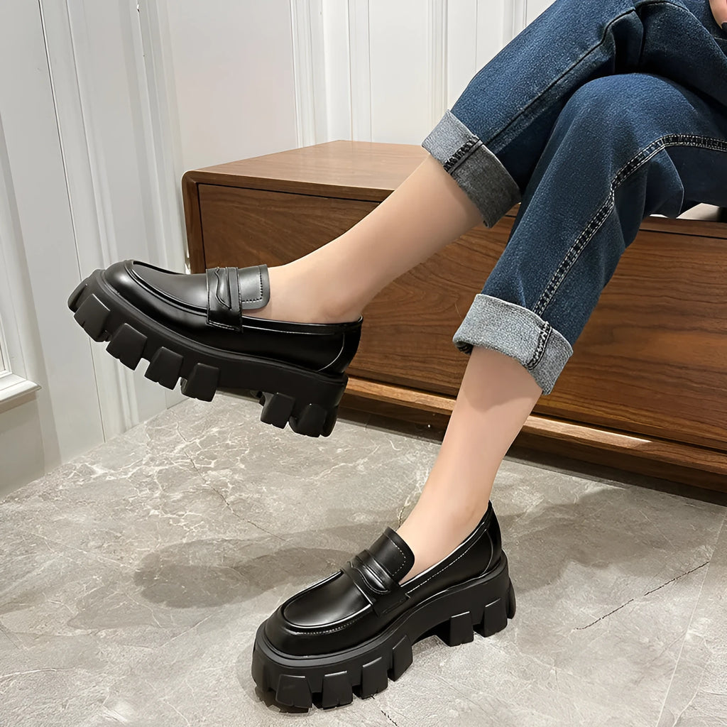 Men's wide fit British style loafers in patent leather with a rubber sole and muffin heel.