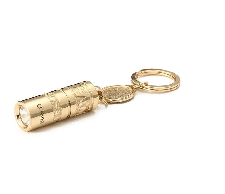 Gold zinc alloy LED flashlight attached to a keyring for outdoor and emergency use.
