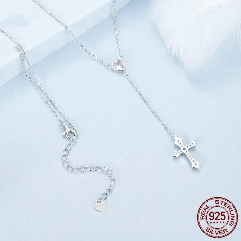 Simple silver love cross pendant necklace with O-ring chain on a female model, colour BSN384.
