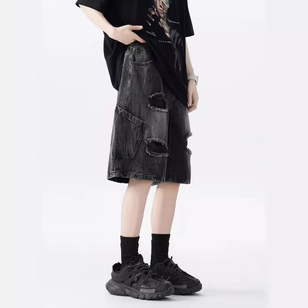 Men's loose fit distressed denim shorts with ripped knee detailing in retro style