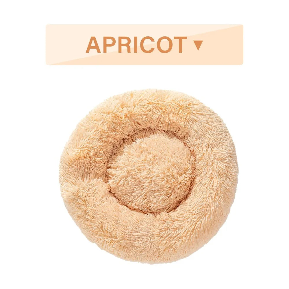 Fluffy donut-shaped dog bed with raised rim in plush fabric, available in multiple colours and four sizes
