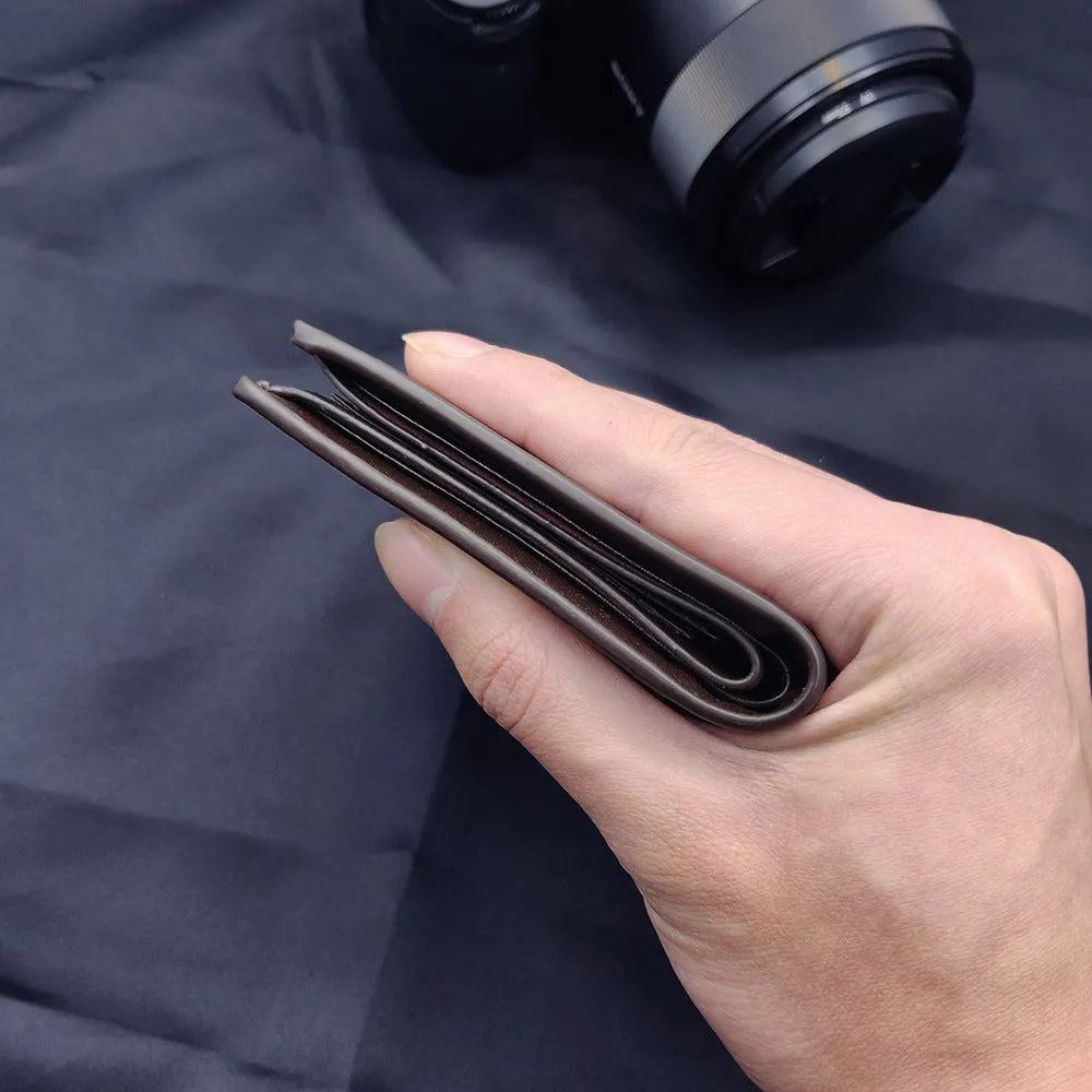 Men's leather wallet with a zipper closure, presented in individual packaging.