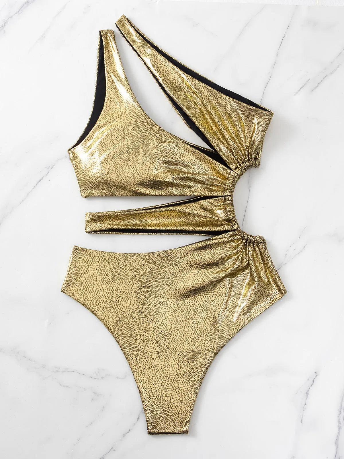 Women's one-piece swimsuit in gold with a backless design.