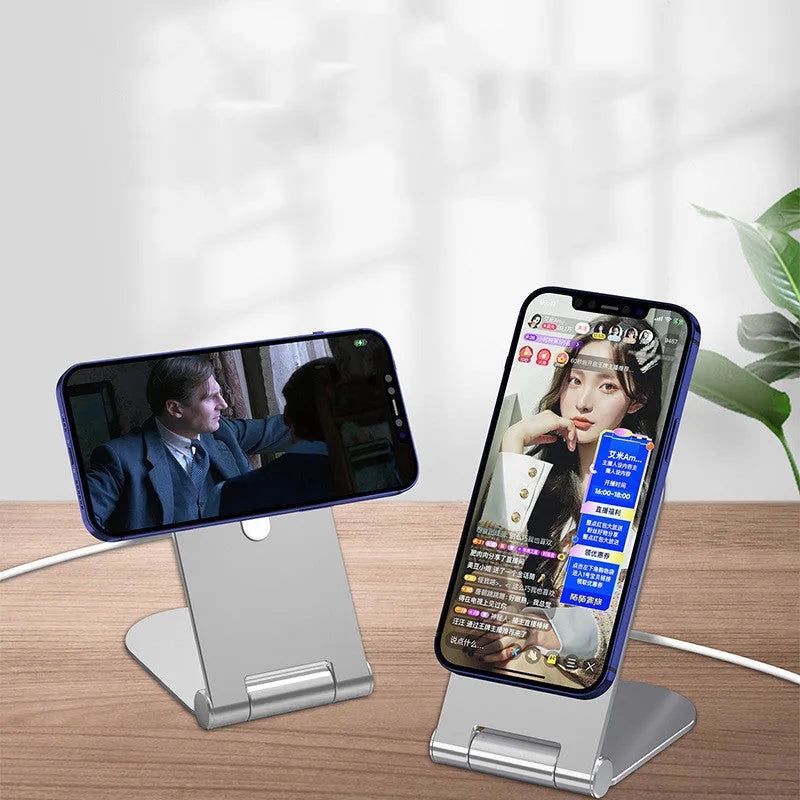 Silver vertical adjustable portable magnetic phone bracket on a metallic surface