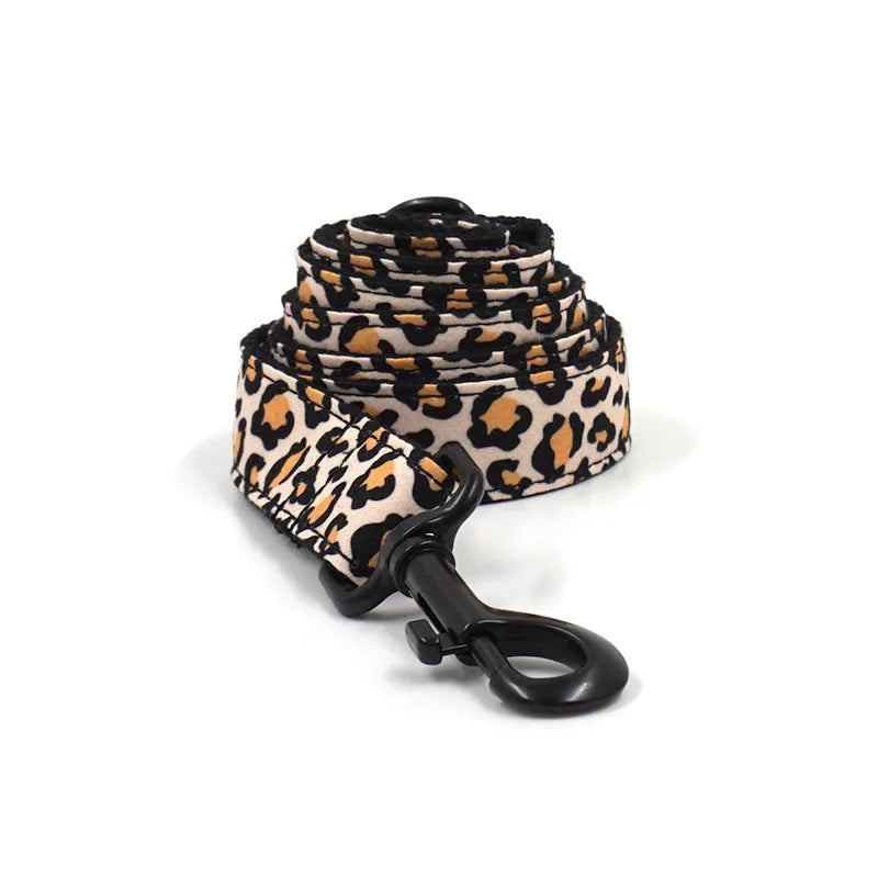 Brown leopard print dog collar and leash set with black buckle on a green background