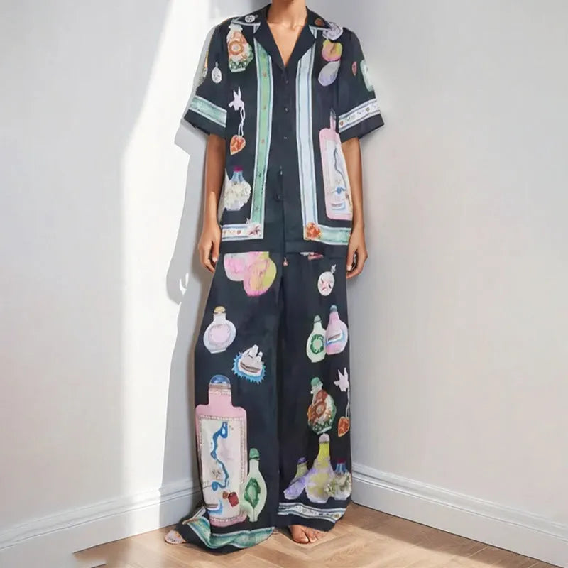Black women's cardigan and trousers co-ord set with a cartoon pattern print.