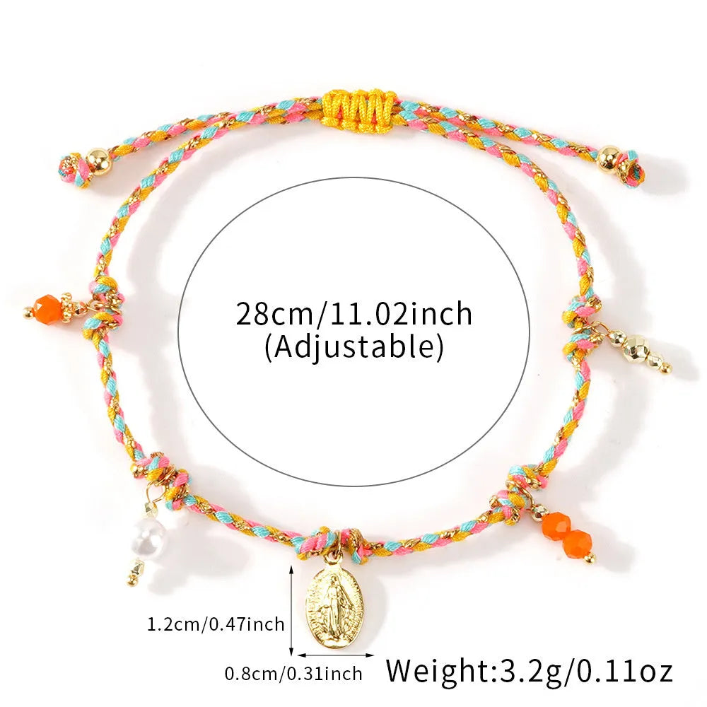 Ethnic style hand-woven bracelet made from colourful braided rope on woman's wrist