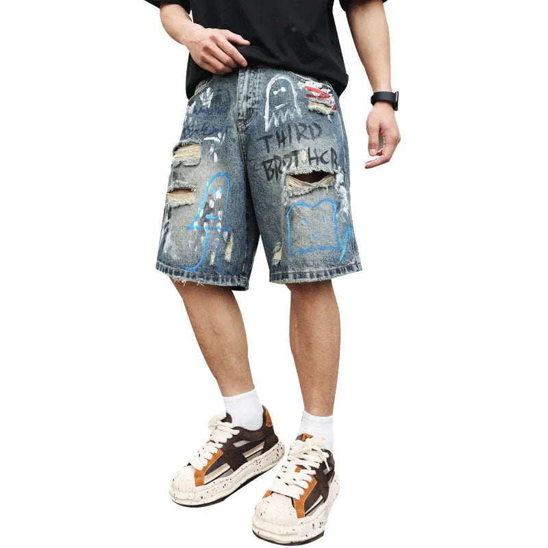 Blue men's denim jeans shorts with graffiti print and ripped details, showing straight leg and zipper fly.
