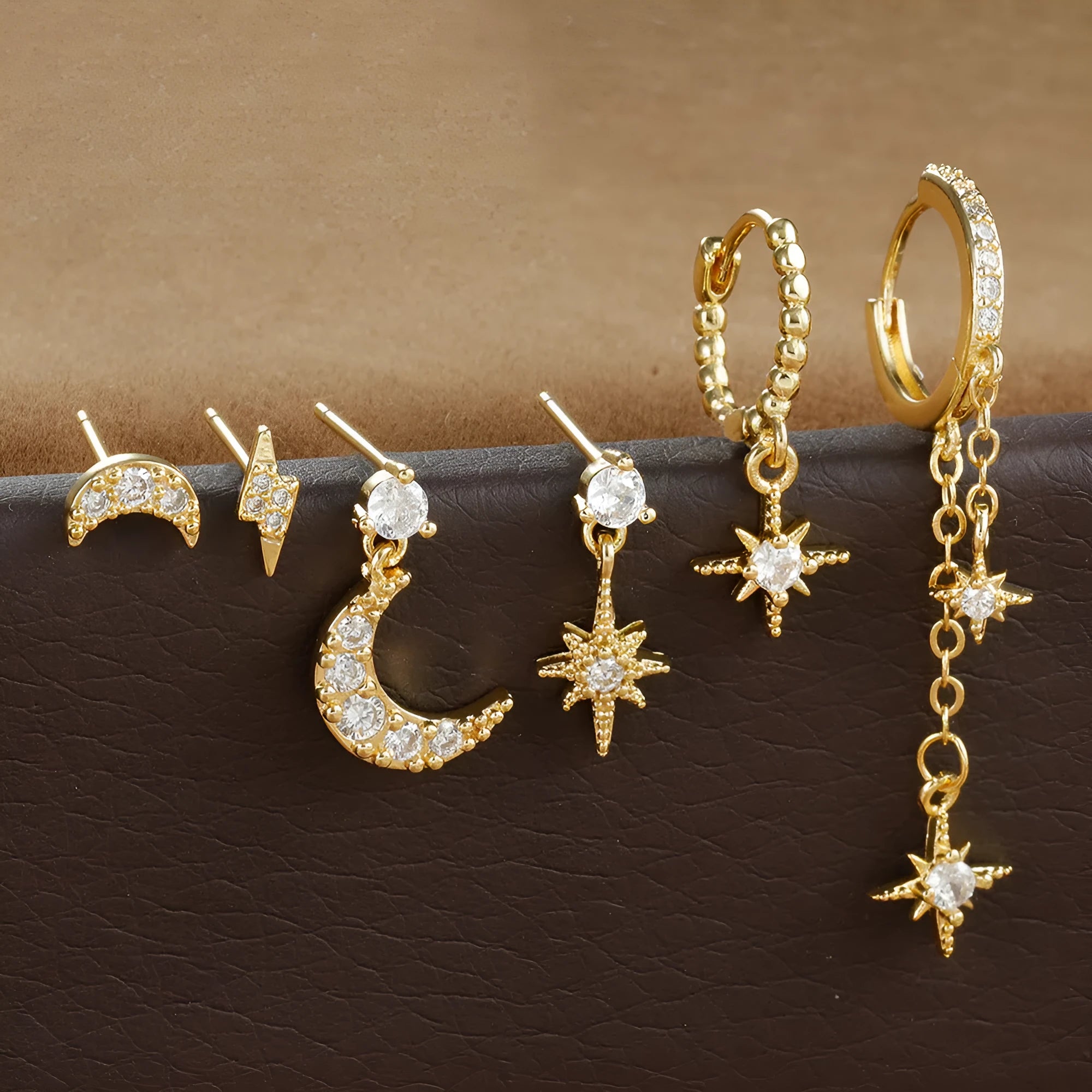Six pairs of gold electroplated earrings including chain tassel designs and zircon studs for women