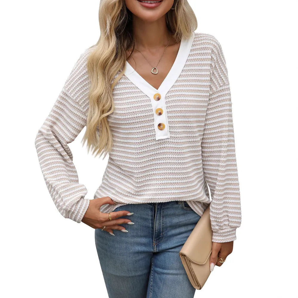 Women's loose-fitting apricot V-neck pullover top with button detail and patchwork design on long sleeves.