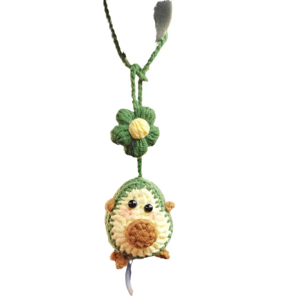 Handmade crocheted avocado-shaped and rainbow pattern car pendants made from wool yarn.