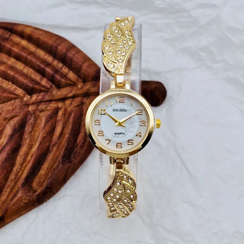 Stainless steel women's watch with round dial on wrist, showing Vachette clasp buckle