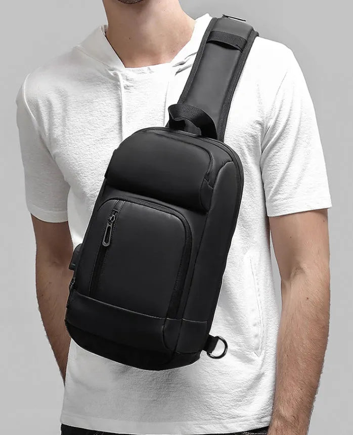 Black medium outdoor shoulder bag showing computer pocket, soft handle, and single air cushion strap.