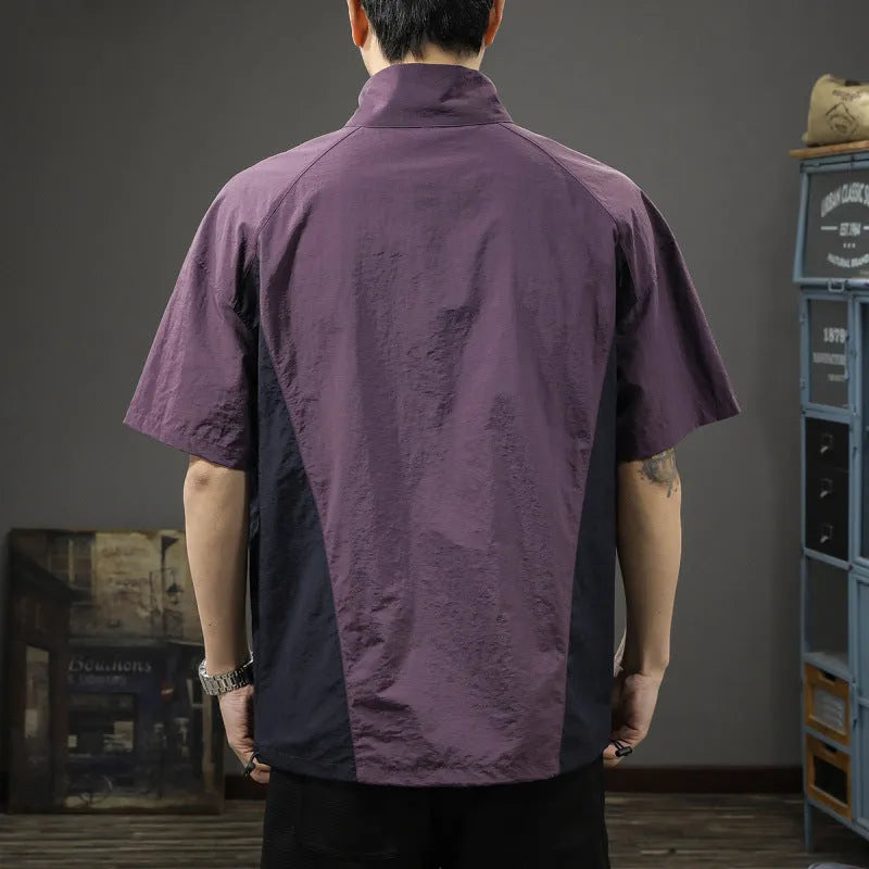 Brown men's loose fit short sleeve shirt with a half-zip stand collar, shown flat.