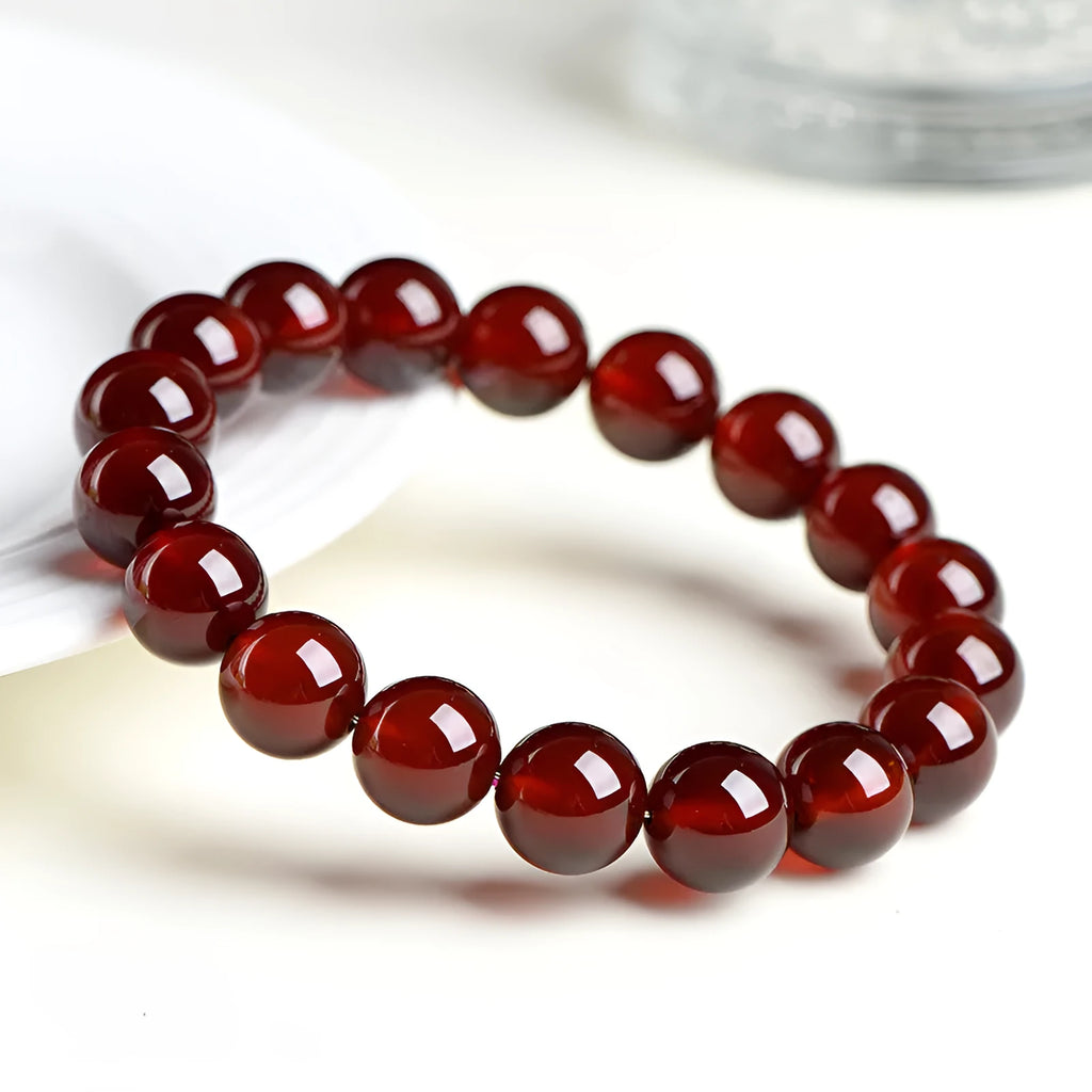 Natural orange red garnet ball bracelet with spherical crystal beads and traditional Ruyi decorative element