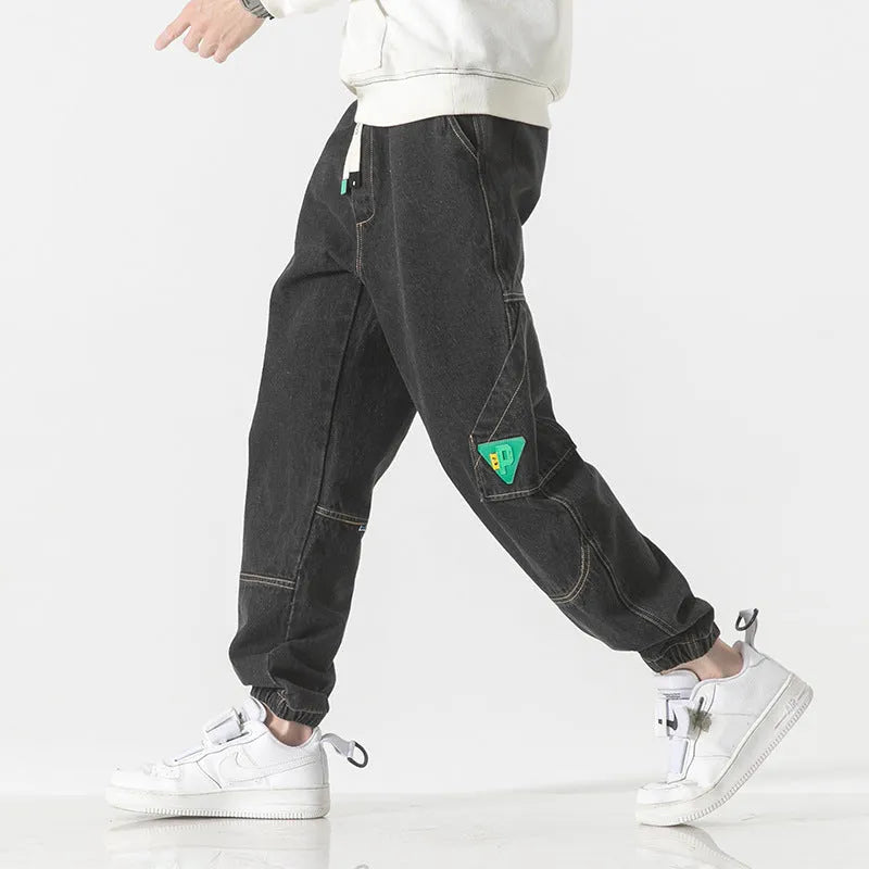 Men's loose-fit tapered cotton trousers in black, blue, and grey colours with mid-waist design
