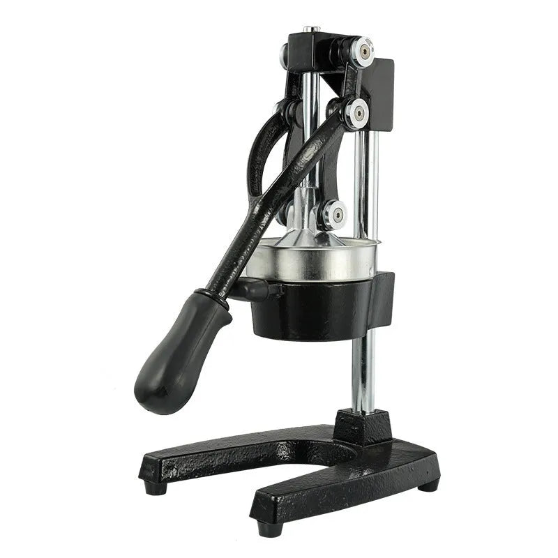 Tall black manual citrus juicer with cast iron base and stainless steel press cone on a kitchen counter