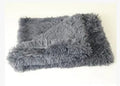 Soft long plush dog blanket in dark grey colour on a wooden floor