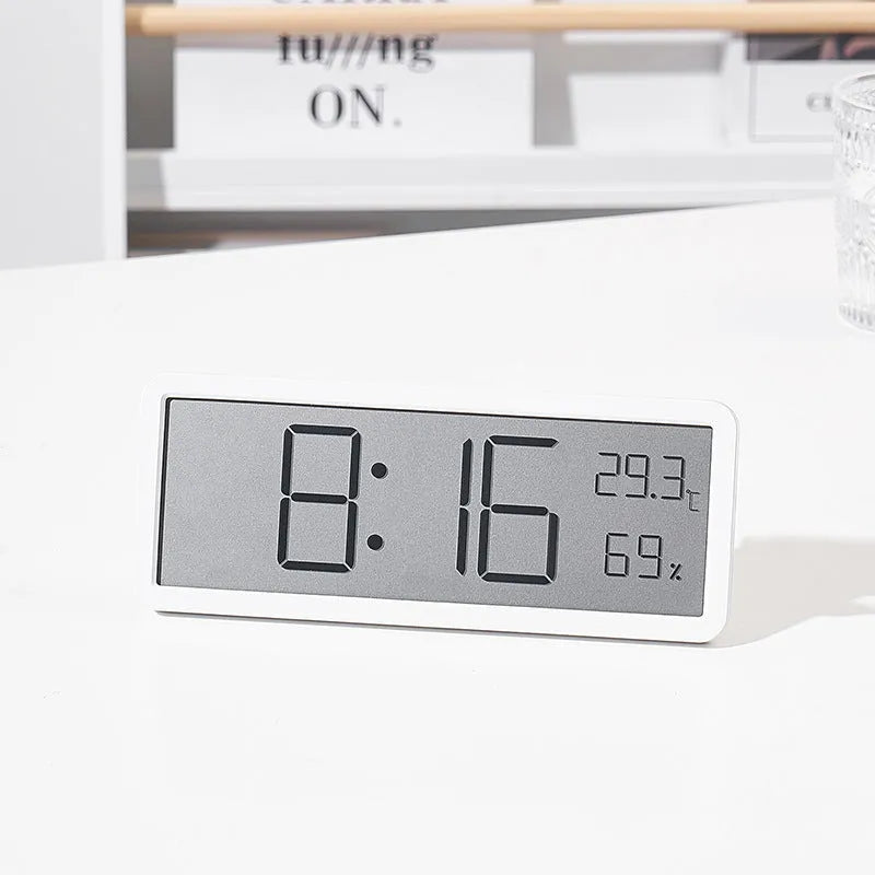 Simple large screen temperature and humidity clock with plastic shell in white Nordic style on a desk