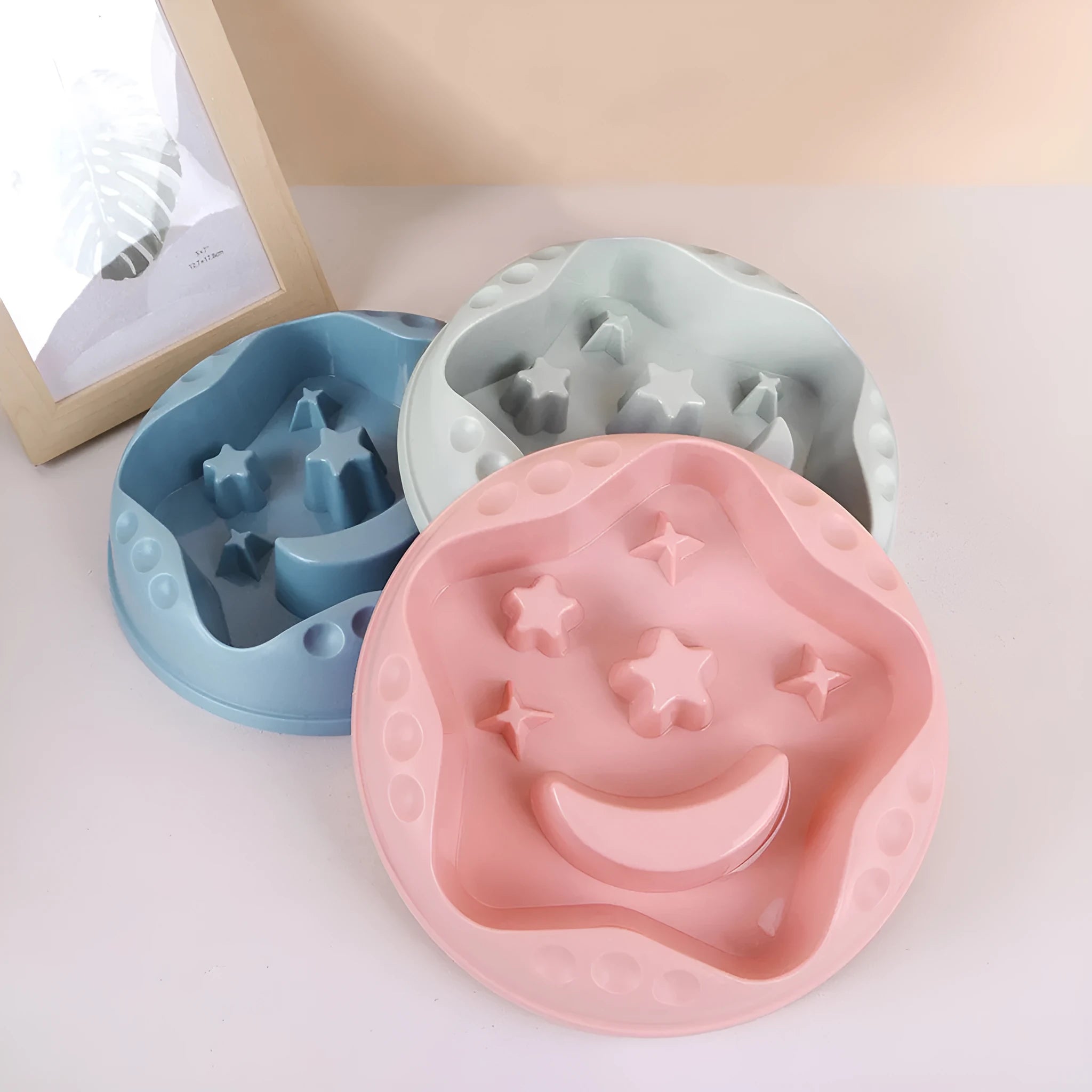 Moon star wings design slow feed dog bowl in blue with raised centre and anti-slip base