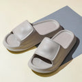 Soft EVA flip-flop slippers with a thick sole, shown in multiple colours including black, pink, and grey.