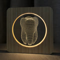 Square tooth-shaped wood colour acrylic night lamp with USB cable on a desk.