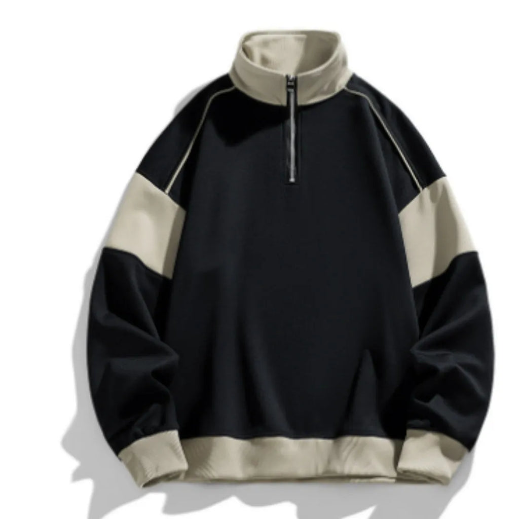 Man modelling a hooded black corduroy sweatshirt with drop shoulders and loose lapels.