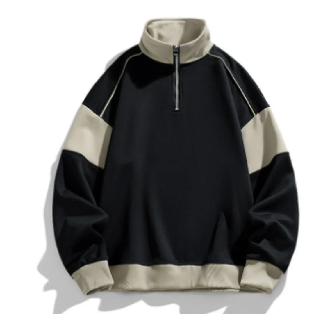 Man modelling a hooded black corduroy sweatshirt with drop shoulders and loose lapels.