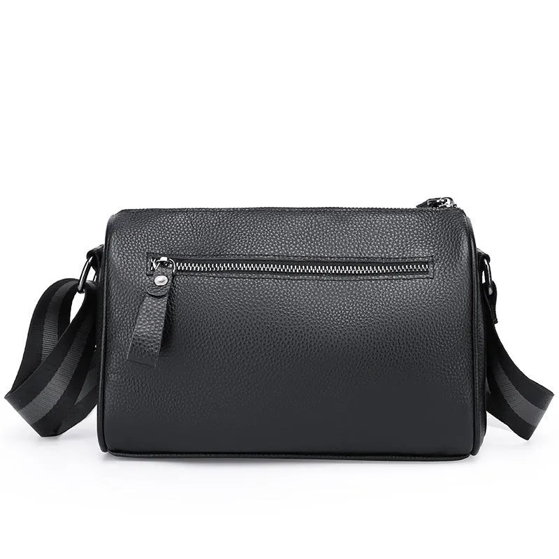 Black genuine leather one-shoulder crossbody bag showing its large size and crossbody strap.