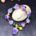 Natural purple amethyst bead bracelet for women with a fu character charm on a white background.
