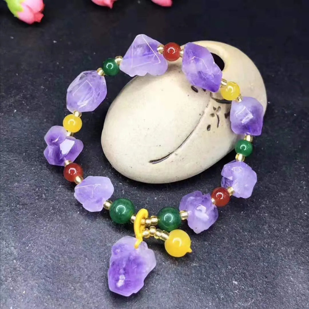 Natural purple amethyst bead bracelet for women with a fu character charm on a white background.