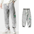 Men's loose-fit tapered cotton trousers in black, blue, and grey colours with mid-waist design