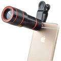 12X magnification black phone telescope lens with adjustable mounting clip on a smartphone
