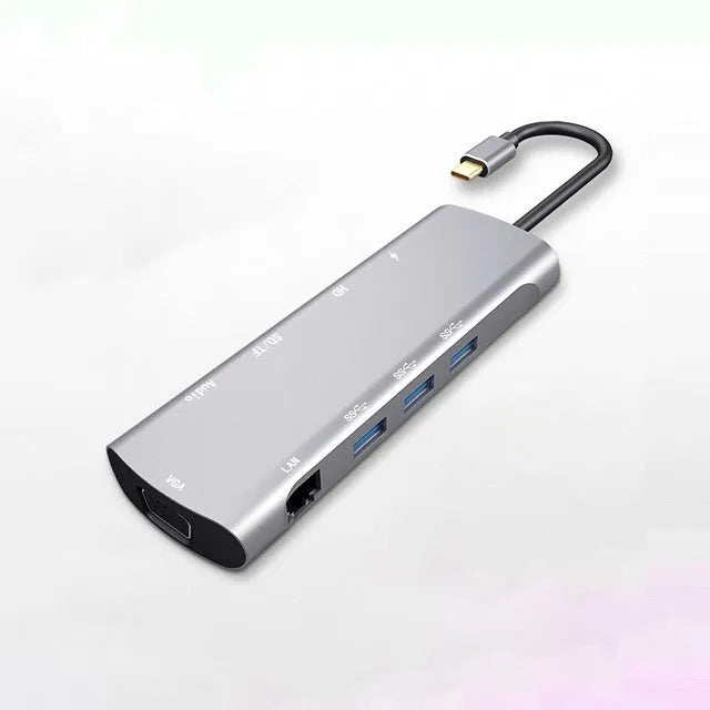 Grey aluminium USB-C docking station with HDMI, VGA, and USB ports on 140mm cable