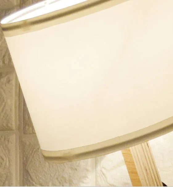 Creative small humanoid wooden table lamp with white fabric shade, 22x44x16cm, on bedside table